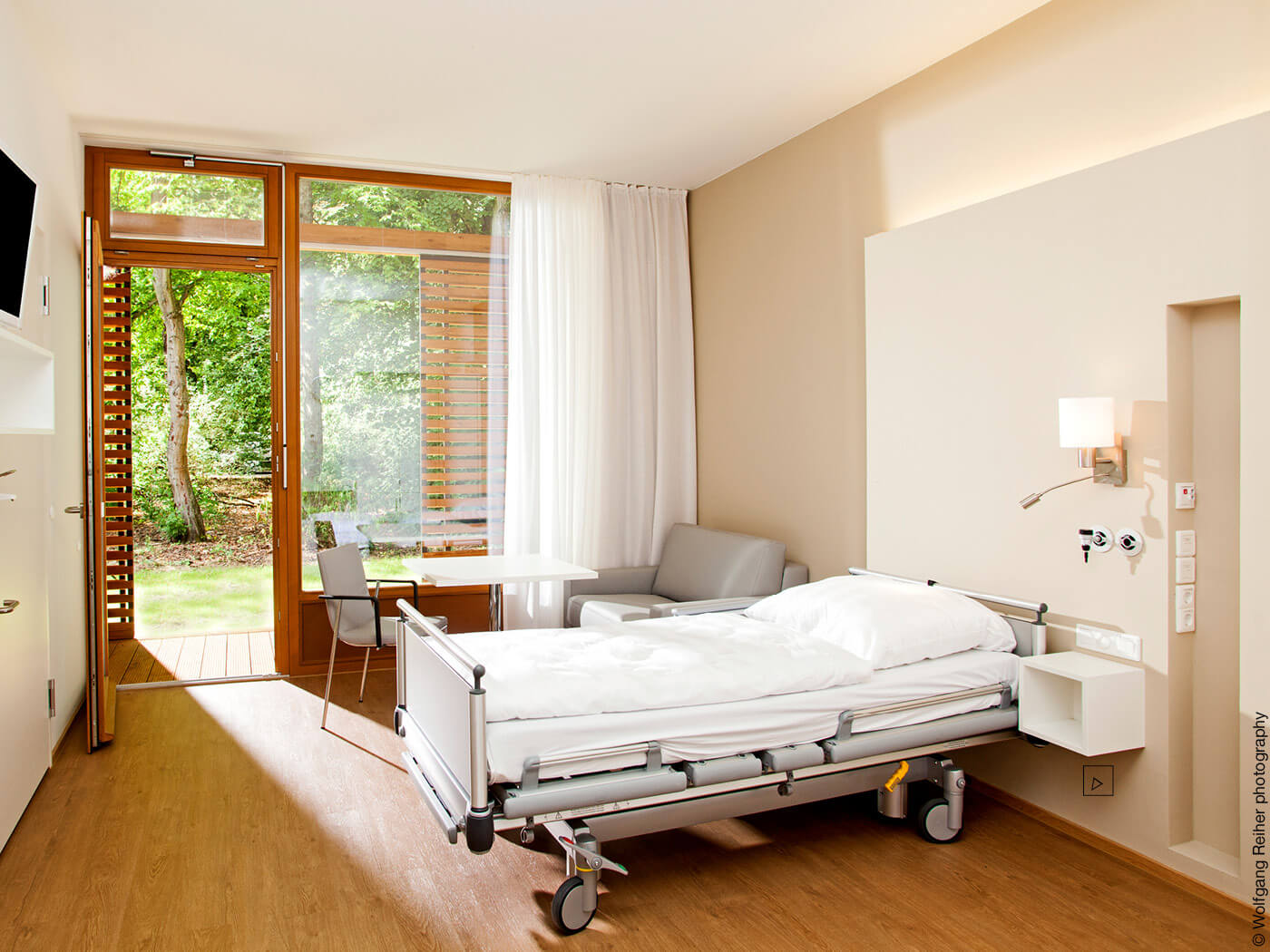Krankenbett in einem kleinen Zimmer mit Terrasse