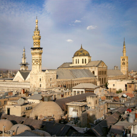 Moschee mit Minaretten über Hausdächern