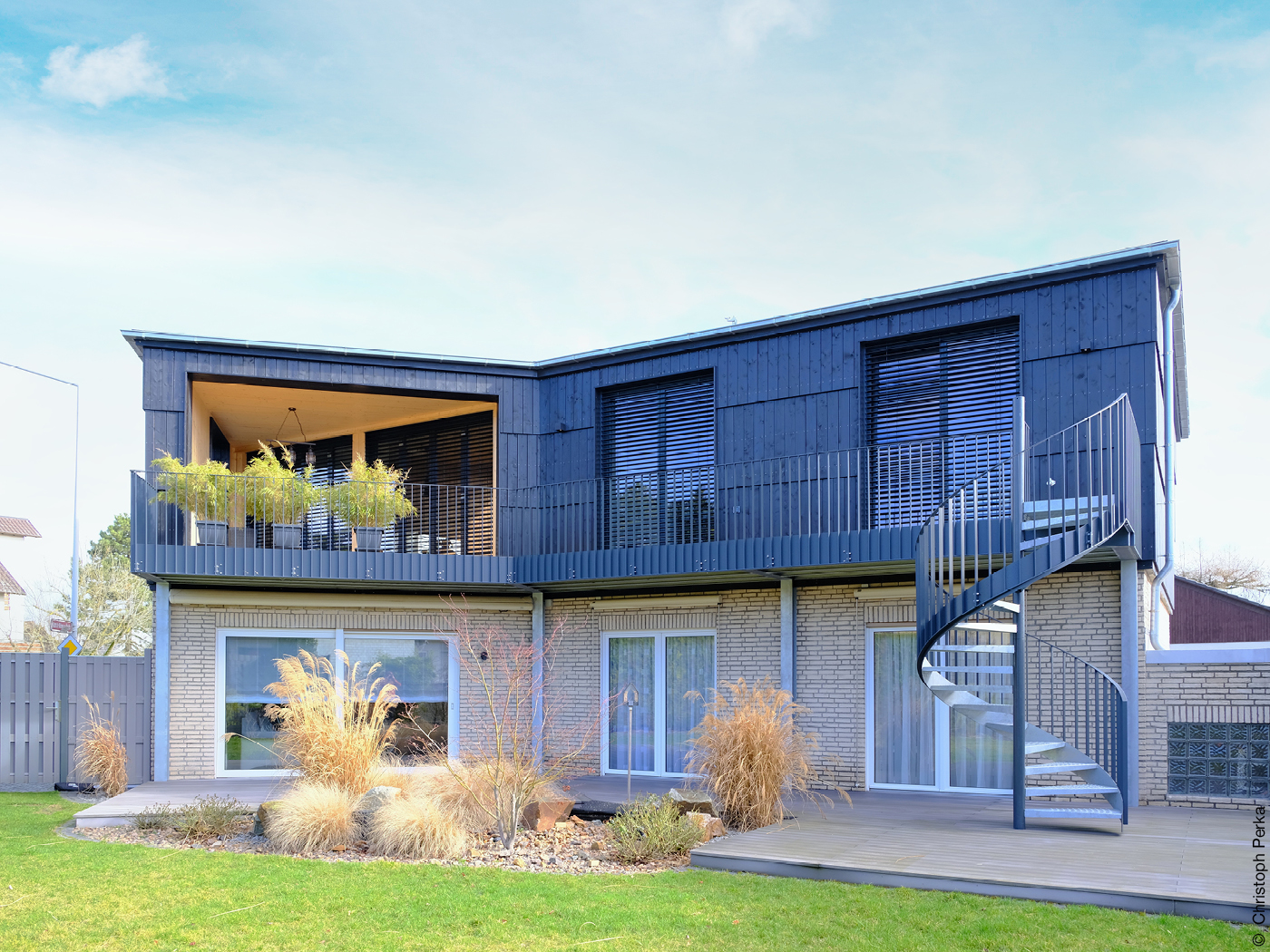 Haus mit Wendeltreppe am Balkon und Garten